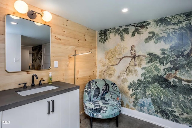 bathroom with vanity and wooden walls