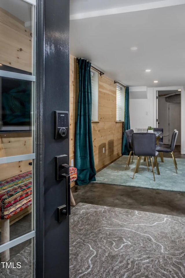 dining room with wood walls