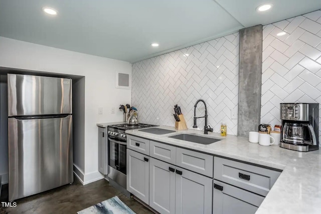 kitchen featuring light stone counters, sink, and stainless steel appliances