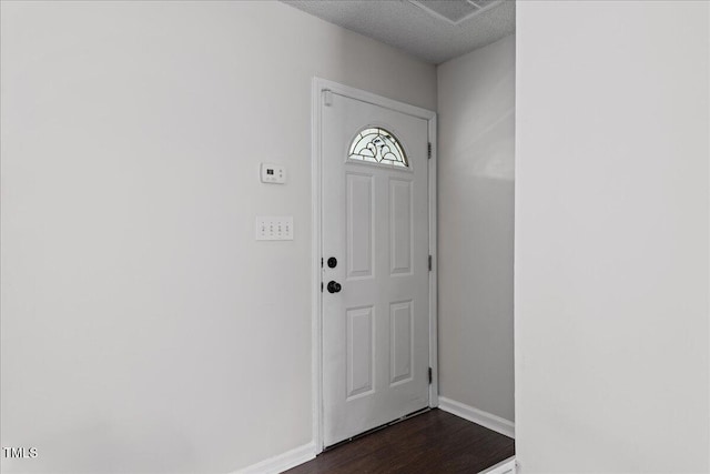 entrance foyer featuring a textured ceiling and dark hardwood / wood-style floors