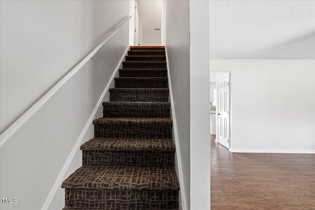 stairs featuring hardwood / wood-style floors