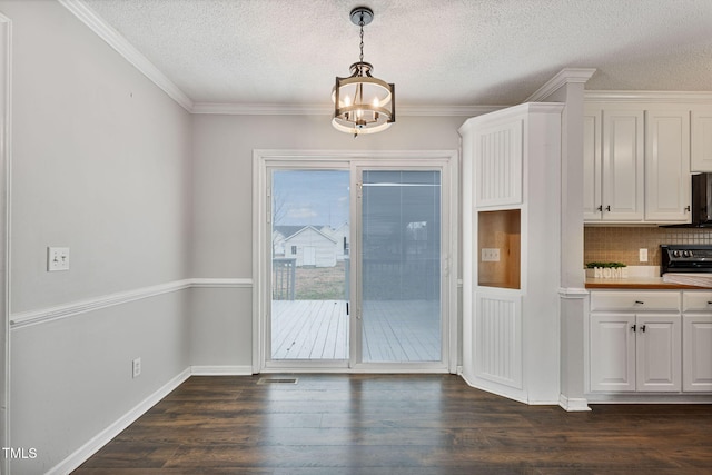 interior space featuring a textured ceiling, dark hardwood / wood-style flooring, crown molding, and a notable chandelier