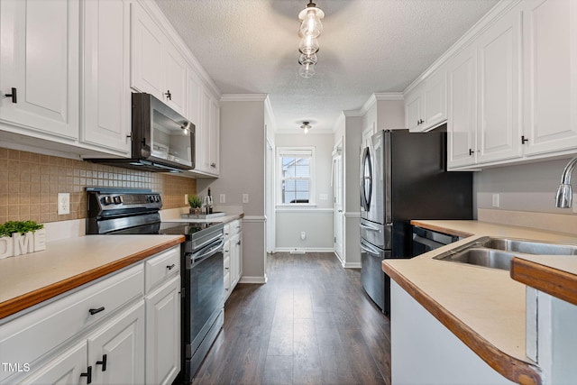 kitchen featuring stainless steel electric range, white cabinets, sink, decorative backsplash, and ornamental molding