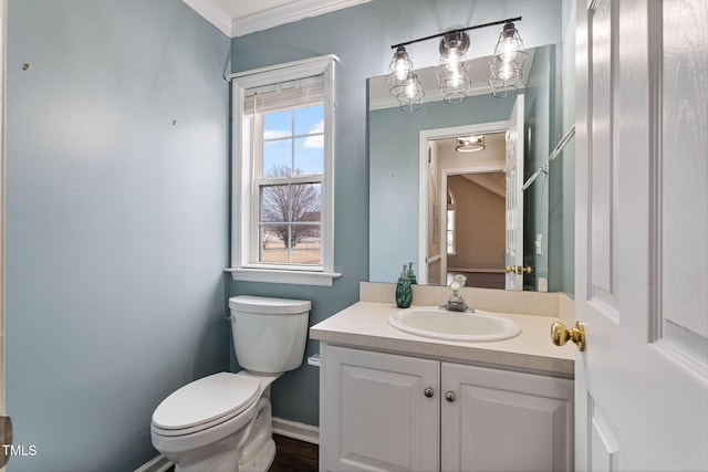 bathroom featuring crown molding, vanity, and toilet