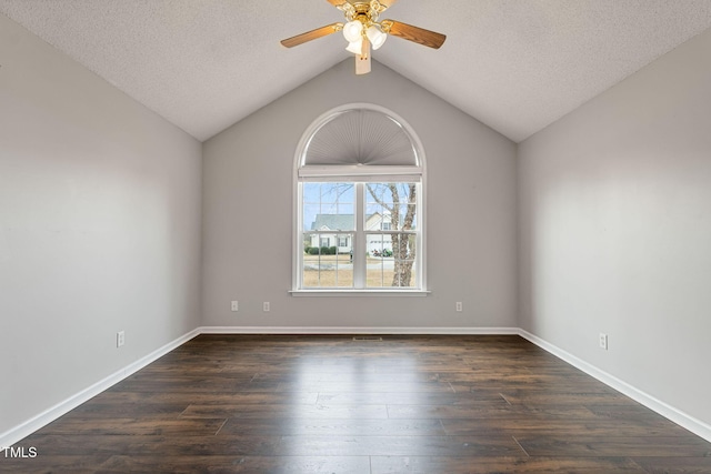 unfurnished room with ceiling fan, dark hardwood / wood-style flooring, lofted ceiling, and a textured ceiling