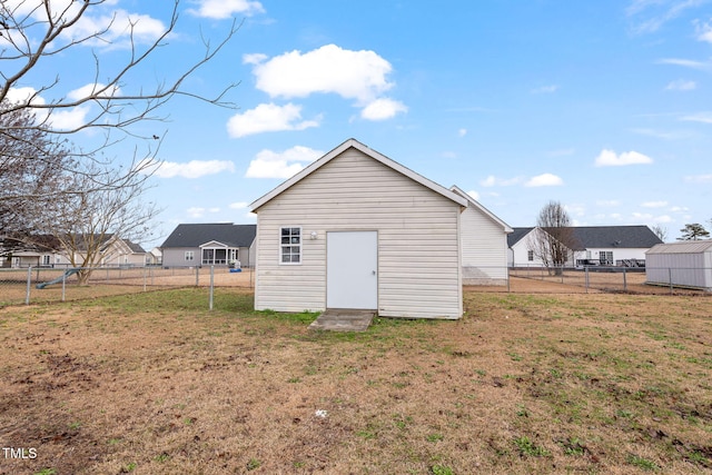 exterior space with a yard and a storage unit