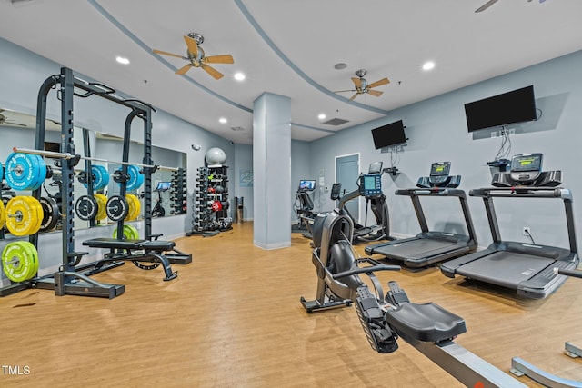 exercise room with light hardwood / wood-style floors and ceiling fan