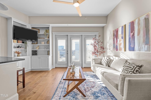 living room featuring ceiling fan and light wood-type flooring