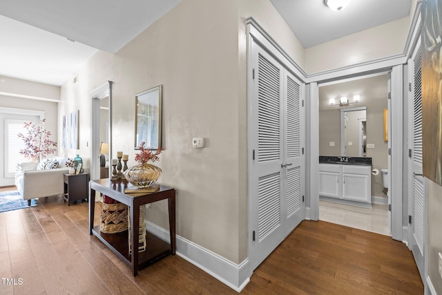 hallway featuring dark hardwood / wood-style floors and sink