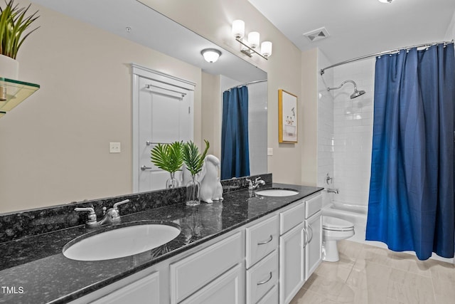 full bathroom featuring vanity, shower / bath combination with curtain, and toilet