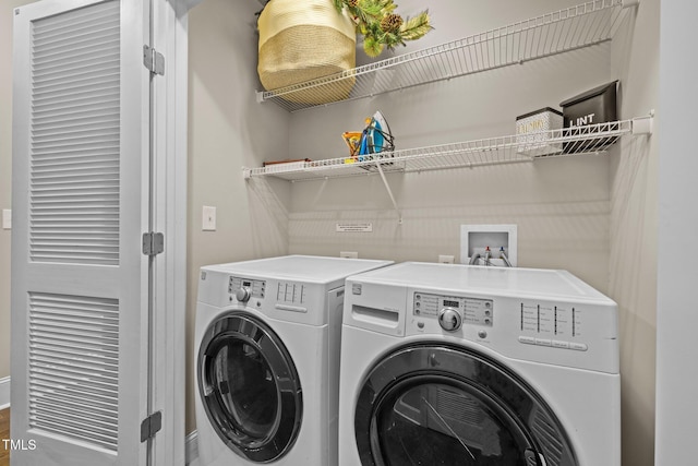 washroom with washing machine and clothes dryer