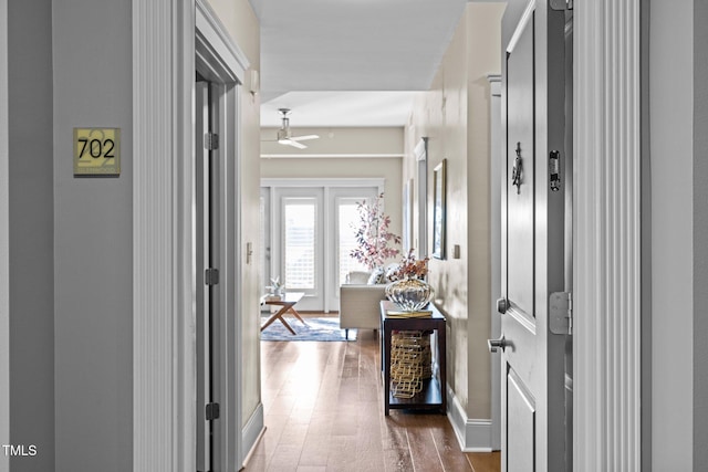 corridor with hardwood / wood-style flooring