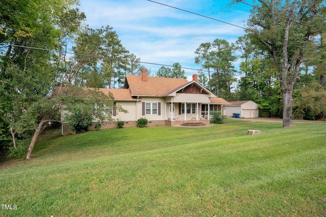 view of front of home featuring a front yard, a shingled roof, a chimney, crawl space, and a detached garage