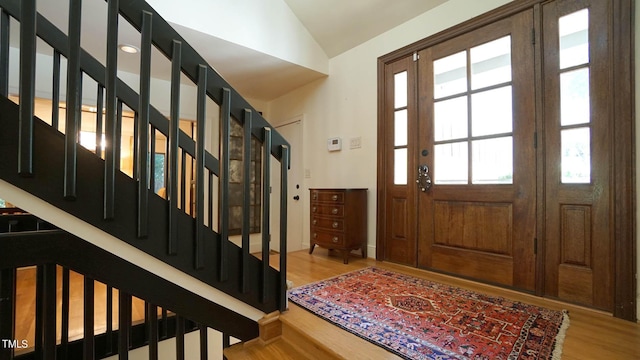 entryway featuring lofted ceiling and hardwood / wood-style flooring