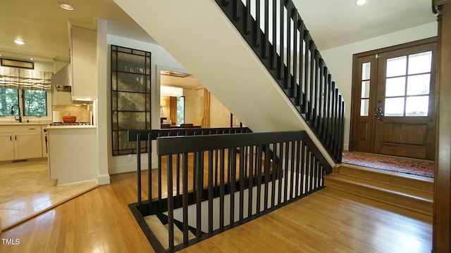 entrance foyer with light wood-type flooring and sink