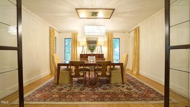 dining space featuring hardwood / wood-style floors and ornamental molding