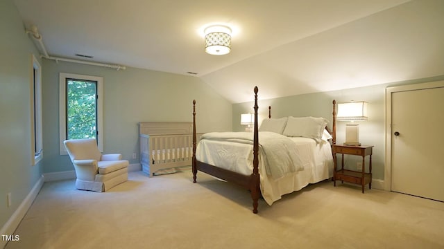 carpeted bedroom featuring vaulted ceiling