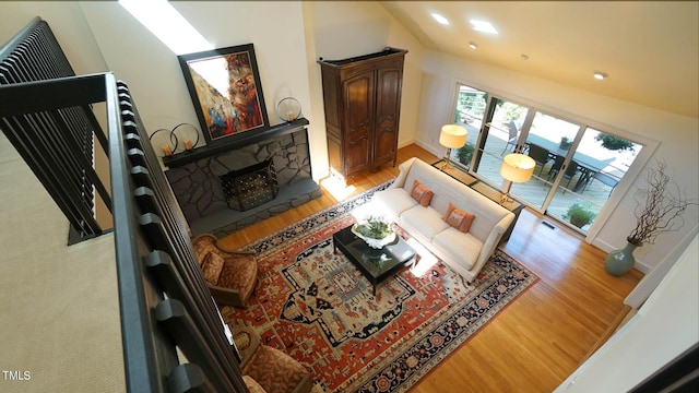 living room featuring lofted ceiling and light hardwood / wood-style flooring