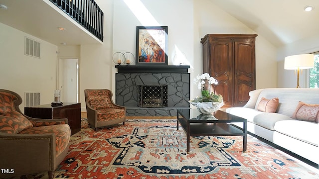 living room with a fireplace and vaulted ceiling