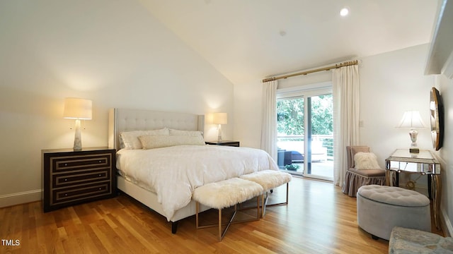 bedroom with access to exterior, light hardwood / wood-style floors, and lofted ceiling