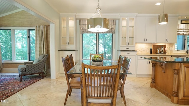 dining space with crown molding