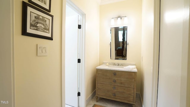 bathroom with tile patterned flooring, vanity, and ornamental molding