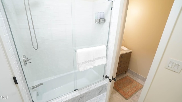 bathroom featuring shower / bath combination with glass door