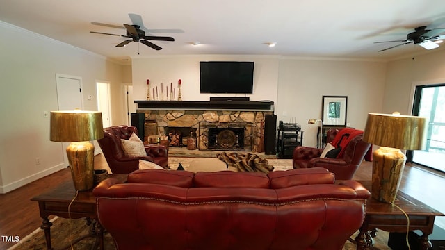 living room with a fireplace, hardwood / wood-style floors, ceiling fan, and ornamental molding