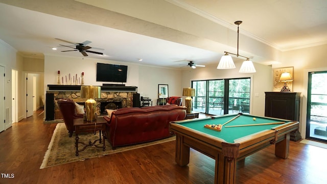 recreation room featuring a stone fireplace, crown molding, dark wood-type flooring, and pool table