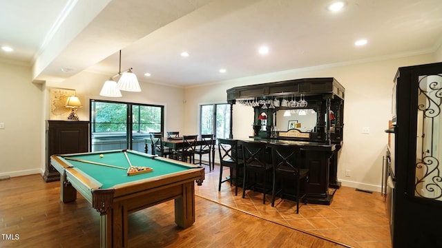 recreation room with bar area, hardwood / wood-style flooring, ornamental molding, and pool table