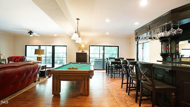 rec room featuring hardwood / wood-style floors, billiards, indoor bar, ceiling fan, and ornamental molding