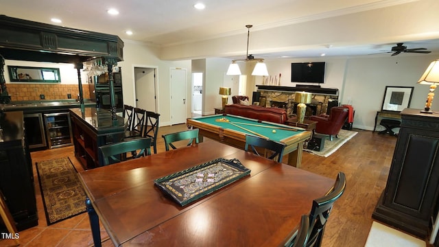 playroom with ceiling fan, a fireplace, ornamental molding, and pool table