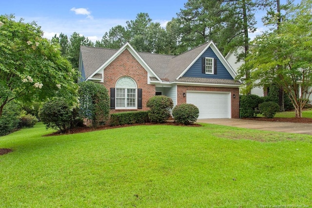 view of property with a garage and a front lawn