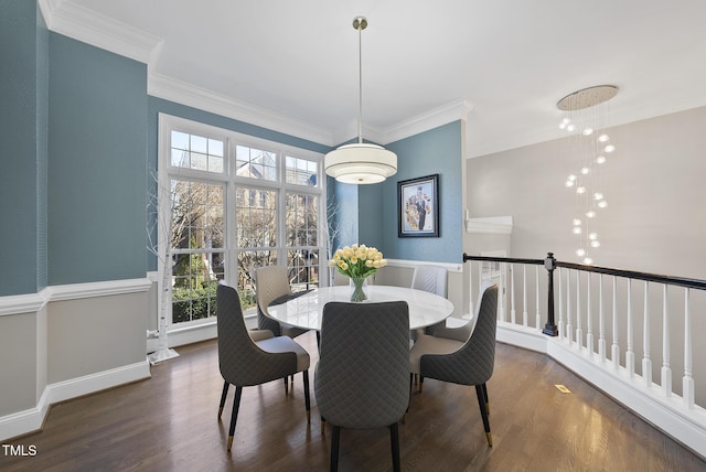 dining area with dark wood-type flooring and ornamental molding