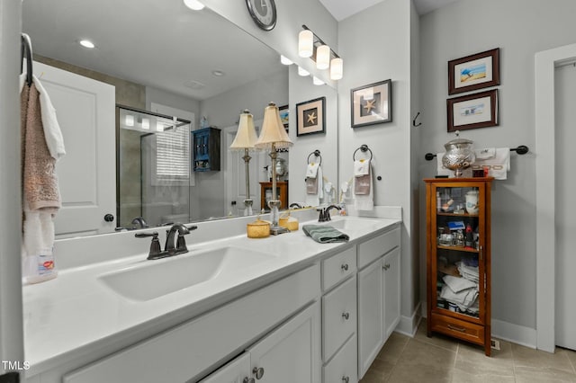 bathroom featuring tile patterned flooring, vanity, and walk in shower