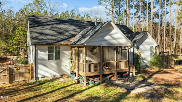 back of property featuring a sunroom and a yard