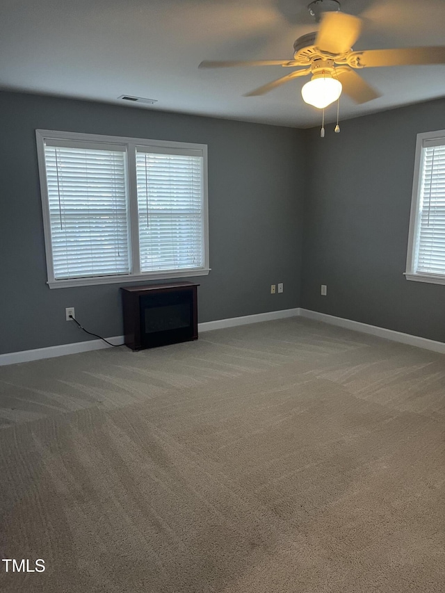 carpeted empty room with ceiling fan