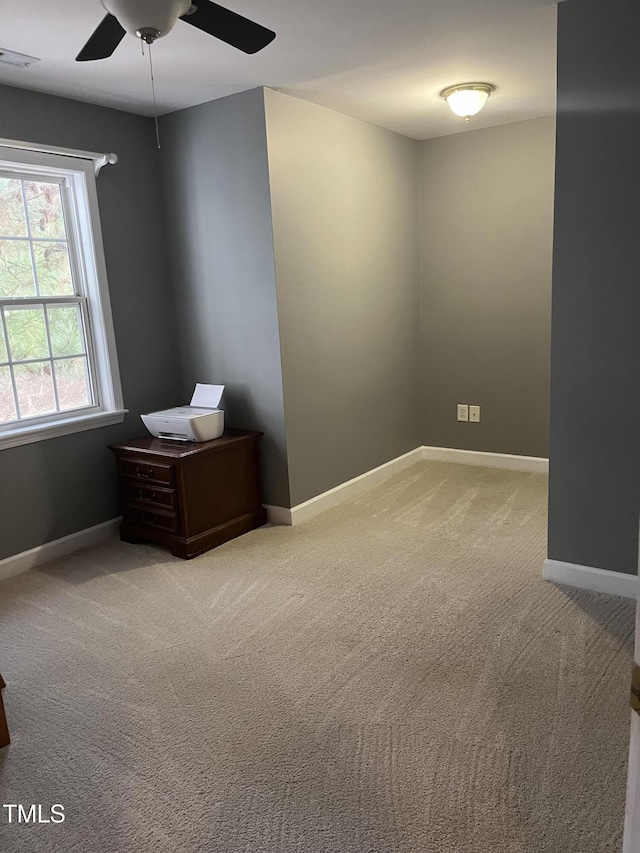 unfurnished room featuring carpet and ceiling fan