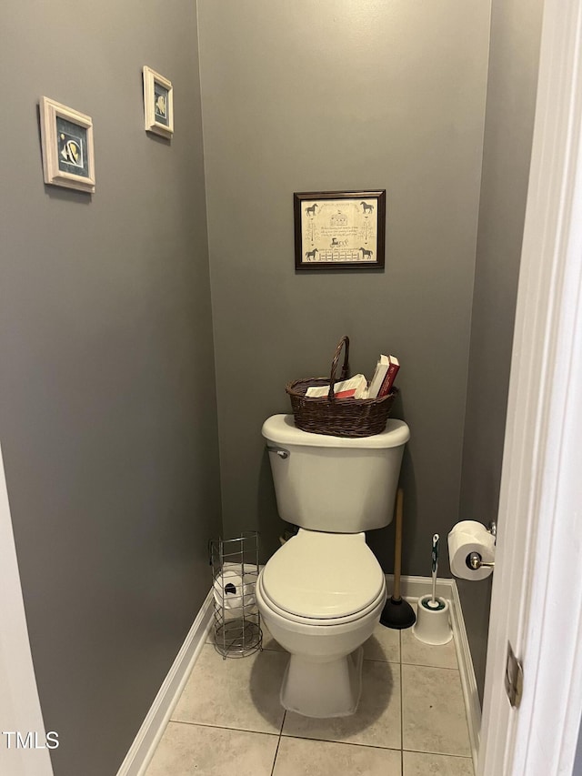 bathroom with toilet and tile patterned floors