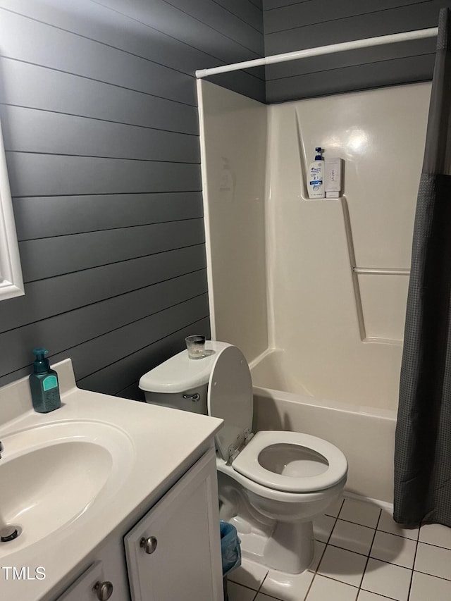 full bathroom with toilet, tile patterned flooring, wooden walls, and shower / bath combination with curtain