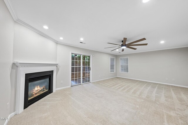 7340 Doverton Ct, Raleigh, NC 27615 - unfurnished living room with recessed lighting, crown molding, a ceiling fan, a glass covered fireplace, and carpet floors