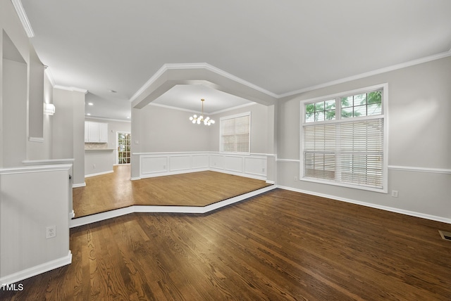 7340 Doverton Ct, Raleigh, NC 27615 - empty room with a chandelier, dark wood finished floors, crown molding, and baseboards