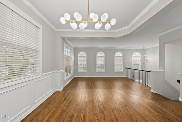 7340 Doverton Ct, Raleigh, NC 27615 - foyer with a chandelier, wood finished floors, plenty of natural light, and ornamental molding