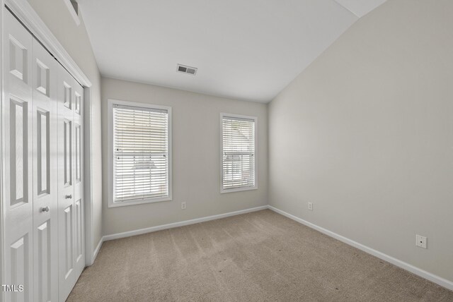 7340 Doverton Ct, Raleigh, NC 27615 - unfurnished bedroom with baseboards, light carpet, and a closet