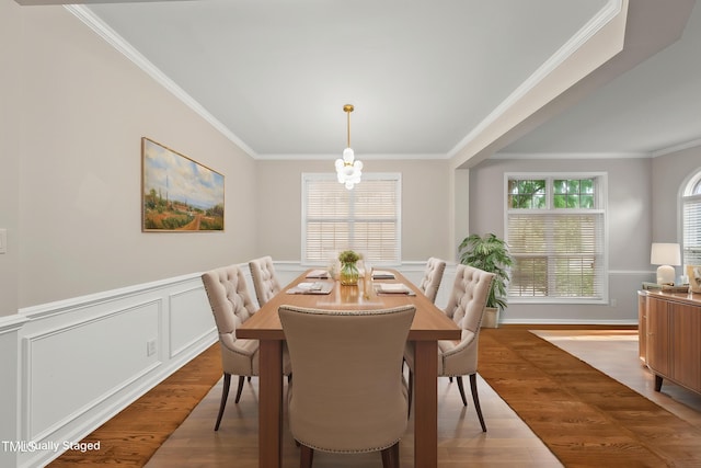 7340 Doverton Ct, Raleigh, NC 27615 - dining room with wood finished floors, ornamental molding, a chandelier, and wainscoting