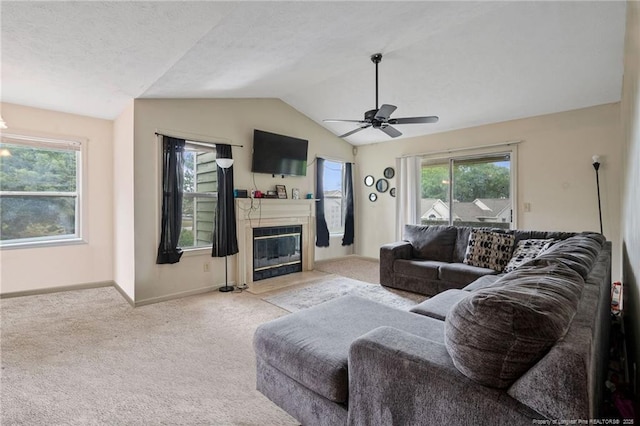 living room with light colored carpet, vaulted ceiling, and ceiling fan