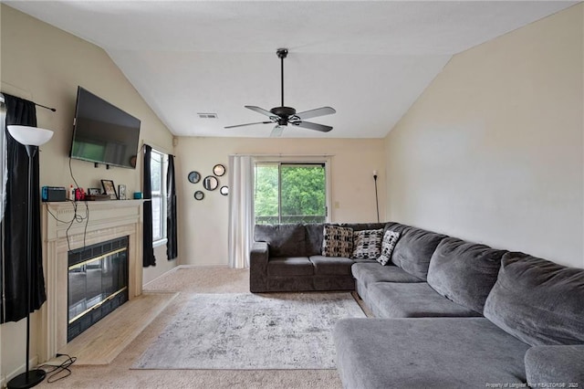 living room featuring ceiling fan, light carpet, and vaulted ceiling