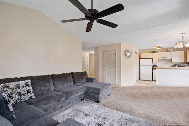 carpeted living room featuring ceiling fan with notable chandelier and lofted ceiling