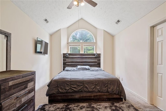 bedroom with ceiling fan, carpet floors, a textured ceiling, and vaulted ceiling