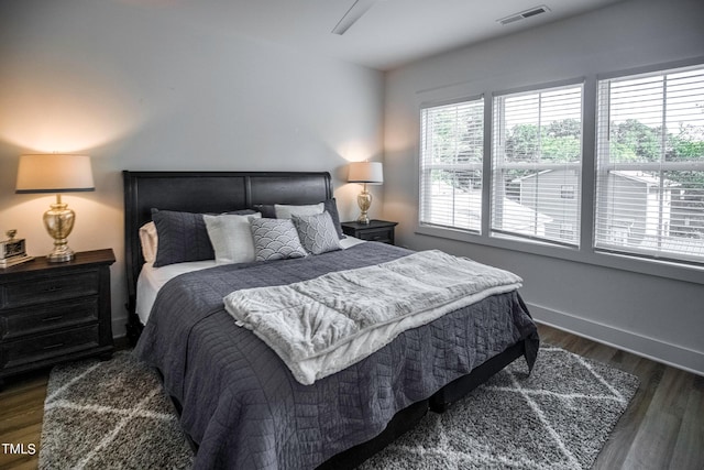 bedroom with ceiling fan and dark hardwood / wood-style floors